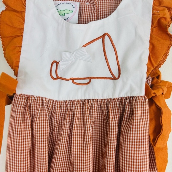 Southern Smocked orange and white gingham checked cheer romper. - Picture 2 of 5